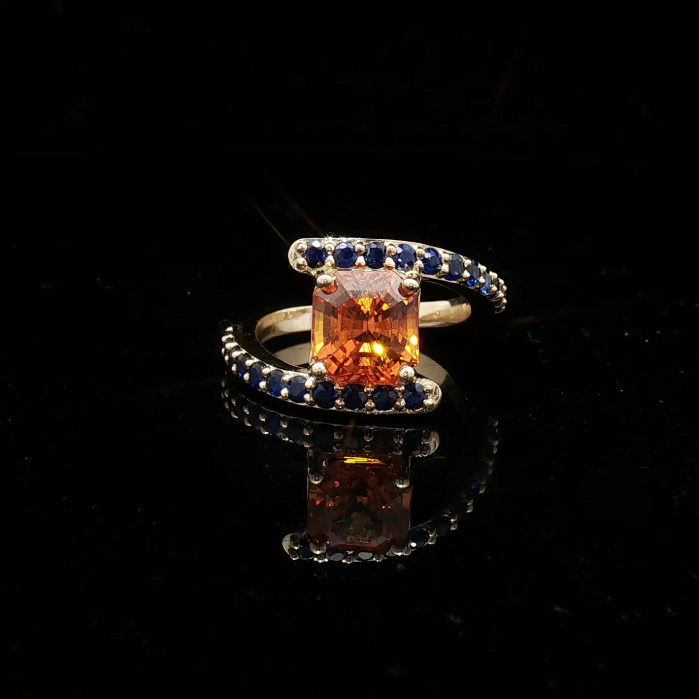 Natural Orange Sapphire Set In 14k Yellow Gold With Blue Sapphire Accent Stones. Regard Jewelry Austin Texas