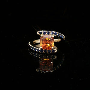 Natural Orange Sapphire Set In 14k Yellow Gold With Blue Sapphire Accent Stones. Regard Jewelry Austin Texas