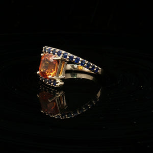 Natural Orange Sapphire Set In 14k Yellow Gold With Blue Sapphire Accent Stones. Regard Jewelry Austin Texas