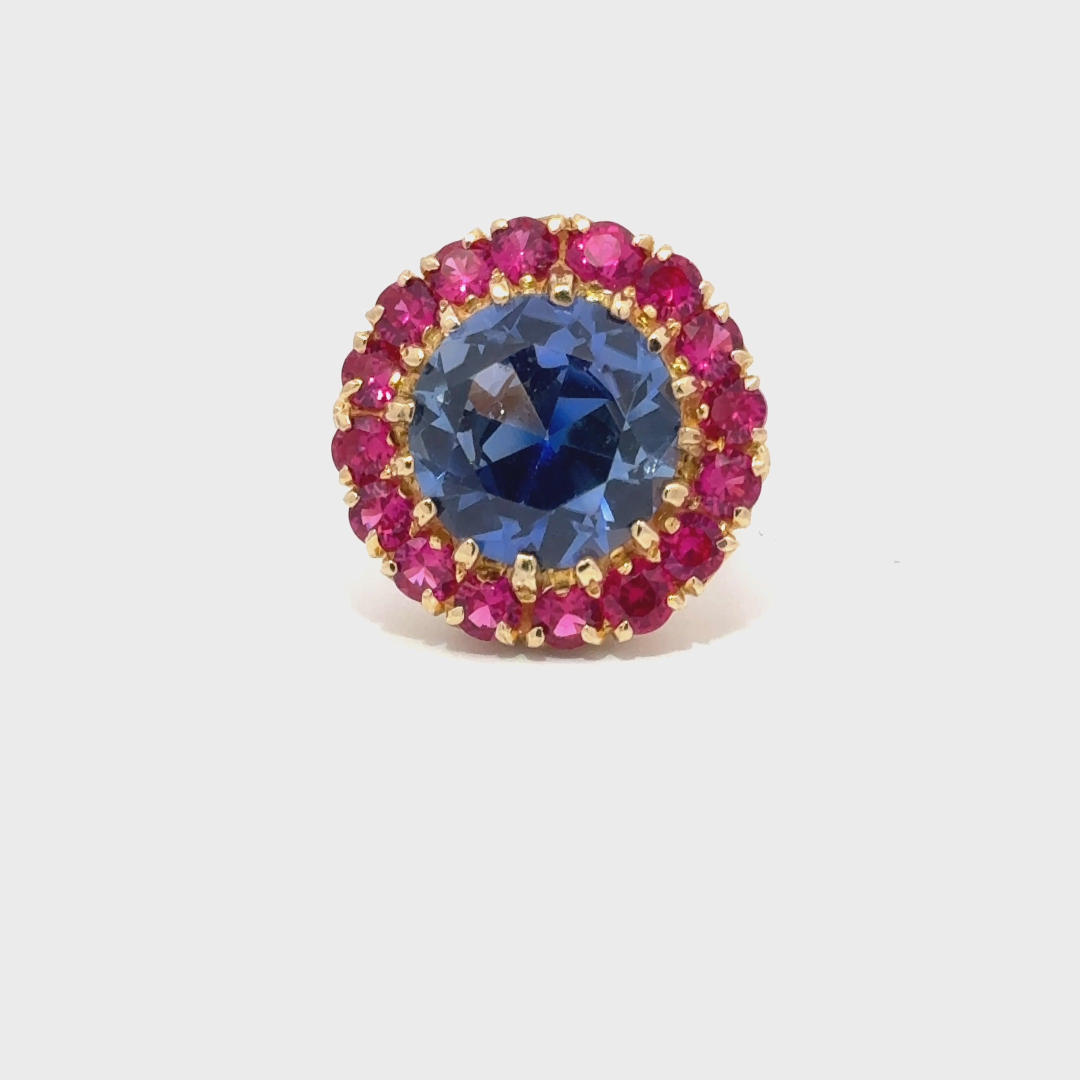 Blue And Red Gemstones On A Gold Ring