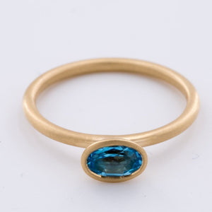 18k Matte Yellow Gold Yumdrop Ring with a Oval Blue Topaz by Kimberly Collins Colored Gems at Regard - Regard Jewelry