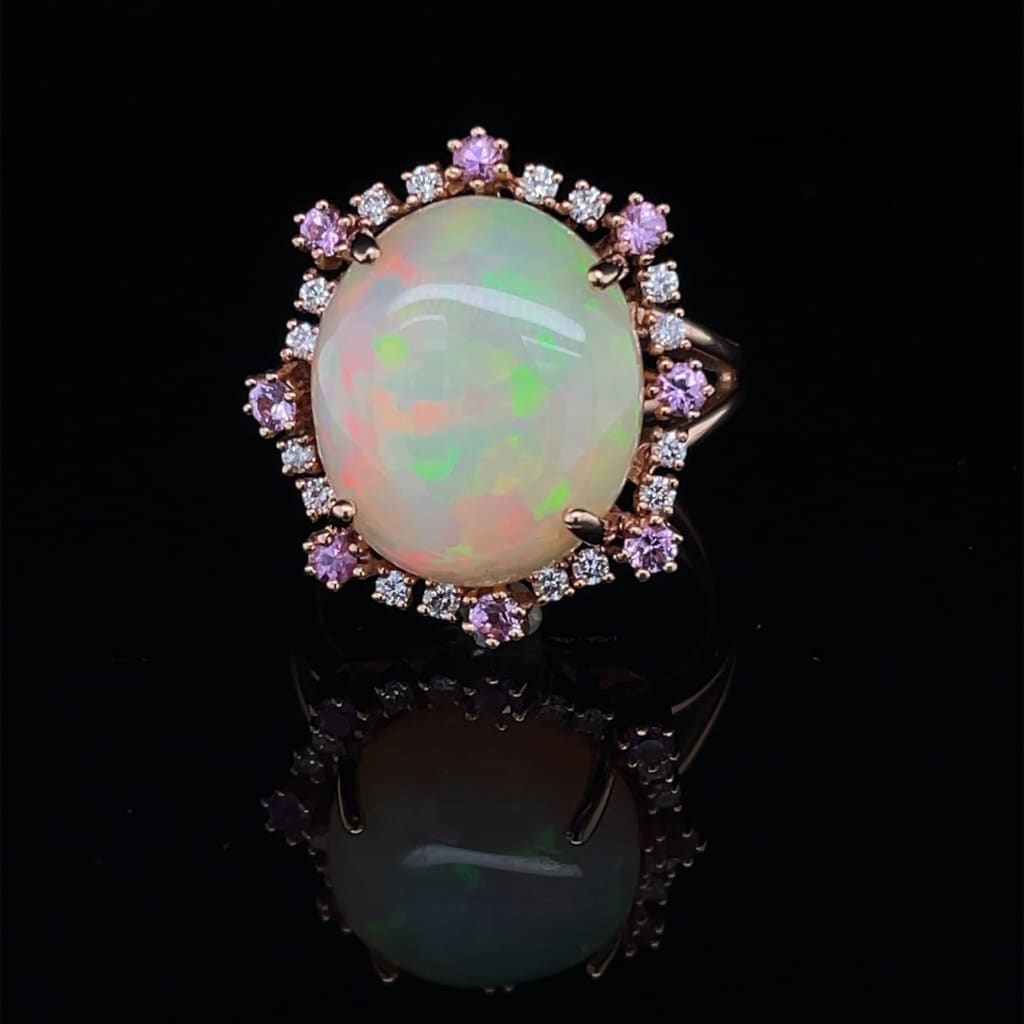 6.81 CT ETHIOPIAN OPAL 18 KARAT RING WITH DIAMOND AND SAPPHIRE ACCENT STONES AT REGARD JEWELRY IN - Regard Jewelry