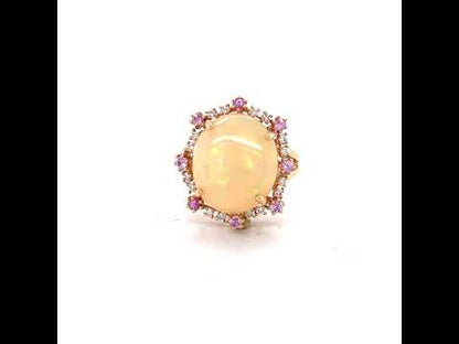 6.81 CT ETHIOPIAN OPAL 18 KARAT RING WITH DIAMOND AND SAPPHIRE ACCENT STONES AT REGARD JEWELRY IN