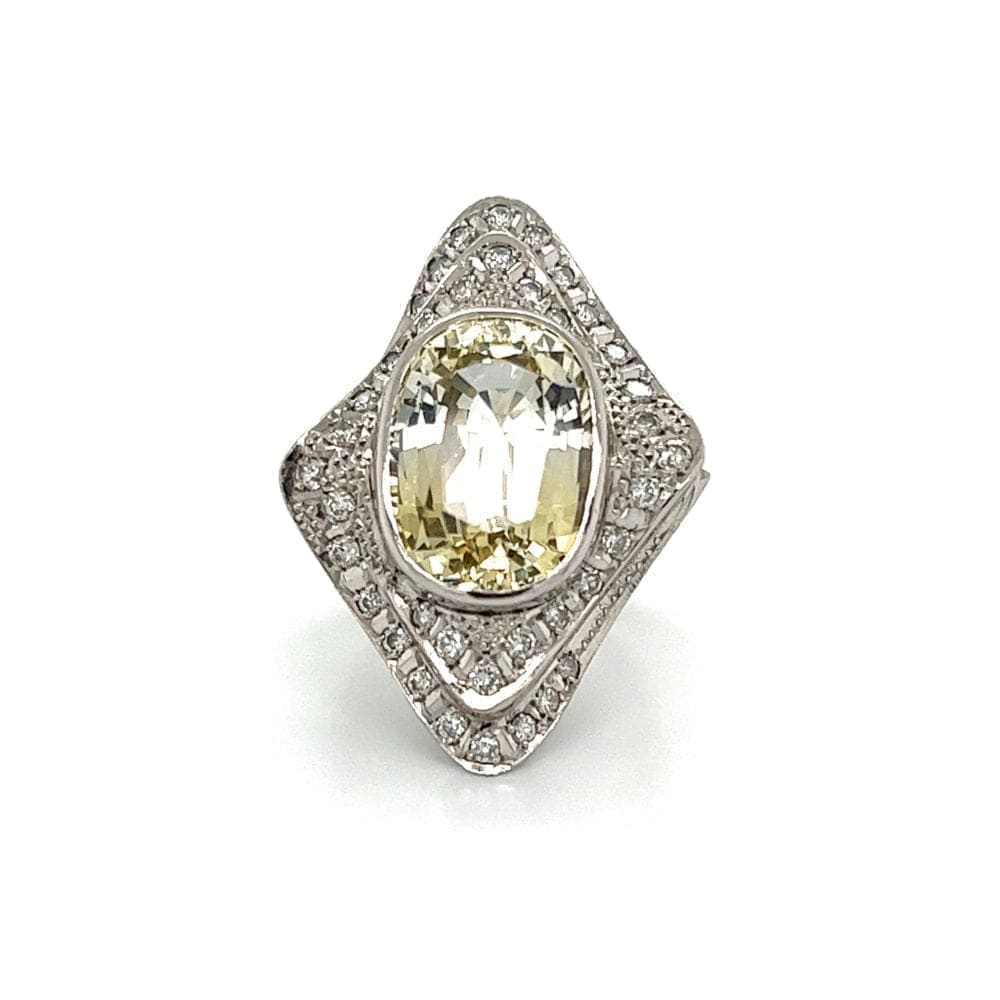 Platinum Oval Yellow Sapphire Ring with Double Diamond Halo at Regard Jewelry in Austin, Texas - Regard Jewelry